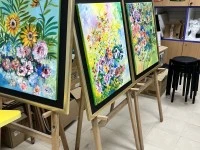 5 boxes of light sticks, art pieces and easel stands, 2 long tables wi...