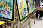 5 boxes of light sticks, art pieces and easel stands, 2 long tables wi...
