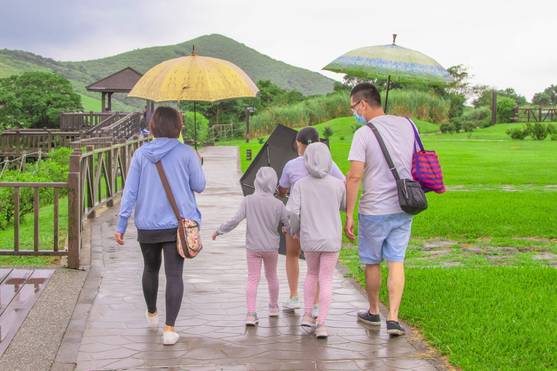 Family caught in tropical rain while traveling in Southeast Asia