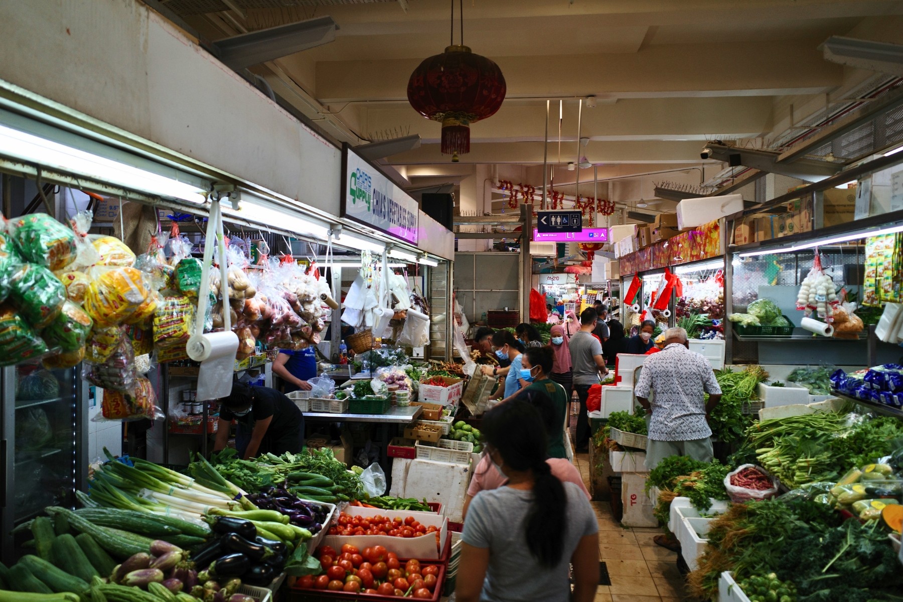 Buying local greens at a wet market in Singapore