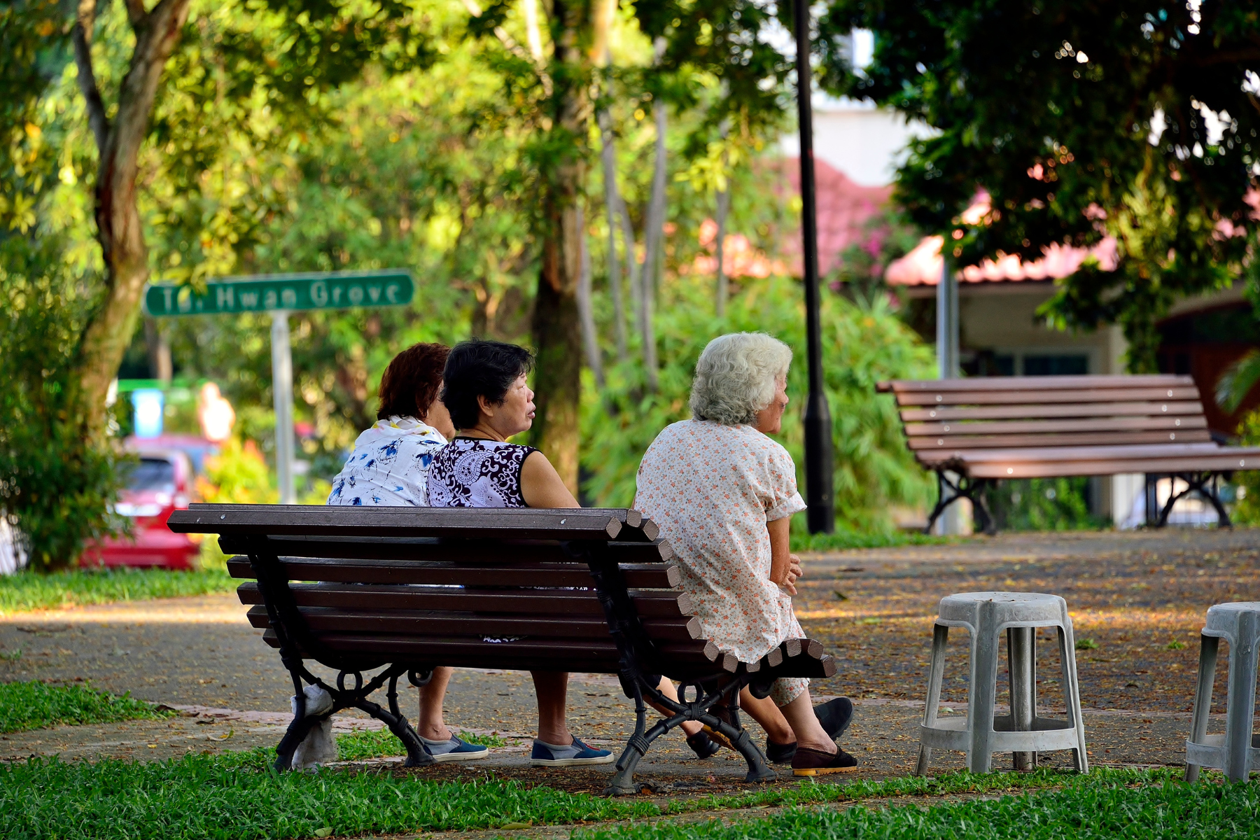 A group of elderly Chinese ladies sitting and relaxing on a bench in a park in Serangoon Gardens
