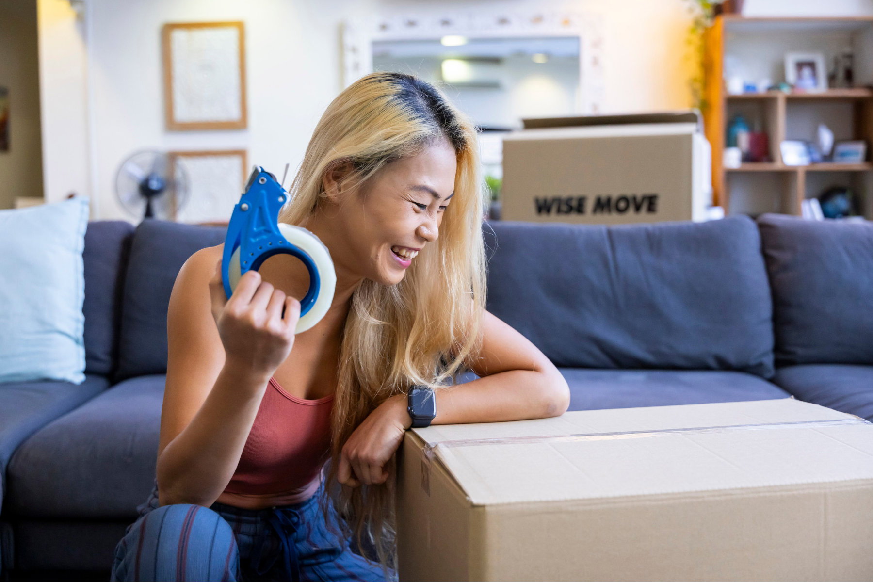 Woman finished taping up box after spring cleaning