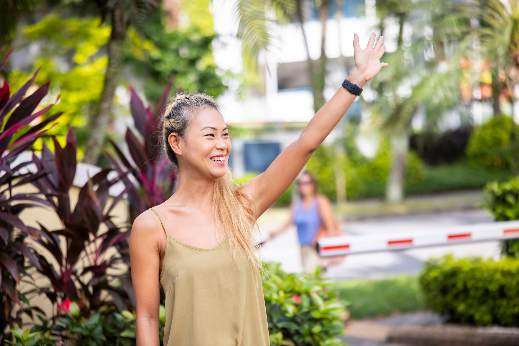 Singaporean woman in short sleeve top waving